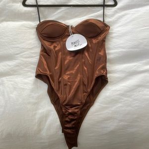 Never been worn tags attached princess Polly copper color bustier body suit